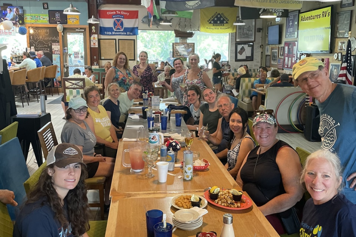 a group of people sitting at a table in a restaurant