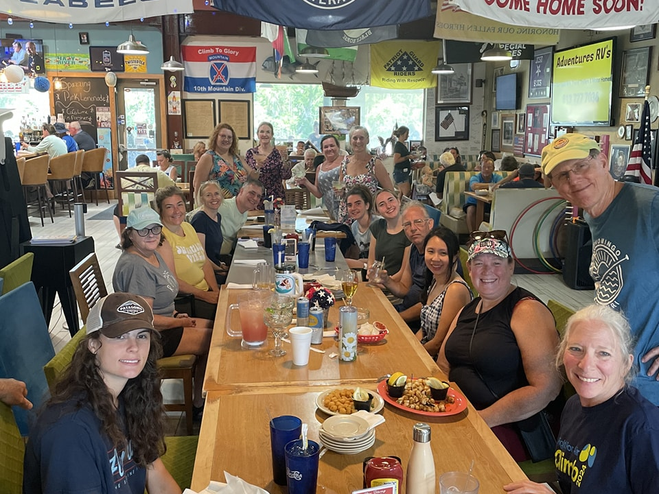 a group of people sitting at a table in a restaurant